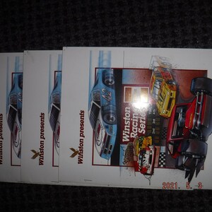 May include: Three vintage Winston Racing Series tickets featuring a blue and white race car with the number 42 on the side. The tickets have the text "Winston presents" and "Winston Racing Series" on them. The tickets also have a date of 2021. 5. 3 and a time of 1:58.