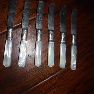 Landers, Frary and Clark Butter spread paddle knives, with Mother of Pearl handle Collars and stamped Sterling X 6