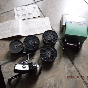 Vintage Fishing Spinning Reels , Includes , DAM Quick super from west  Berlin , Shakespeare Noris 2115 , Penn 710 , Mitchel 310 , 7 items -  Bunting Online Auctions
