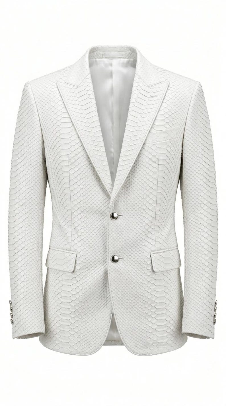 May include: A white blazer with a textured, snakeskin-like pattern. The jacket has a two-button closure, notched lapels, and two front pockets. The sleeves have three buttons at the cuff. The blazer is a tailored fit.