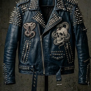 May include: A blue leather jacket with silver metal studs and spikes. The jacket features embroidered patches of a snake and a skull. It has a zipper closure, multiple pockets, and adjustable waist straps. The jacket is displayed on a black hanger.