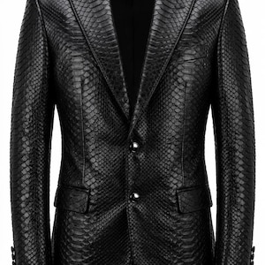May include: A black leather blazer with a snakeskin effect. The jacket features a notched lapel, two front pockets, and two silver buttons. The sleeves have three buttons at the cuff. The blazer is tailored and has a classic fit.