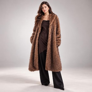 May include: A long, brown faux fur coat with a shaggy texture and wide lapels, worn over a dark brown satin camisole top and black wide-leg trousers. The coat features long sleeves and an open front design, reaching below the knees.