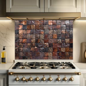May include: A kitchen backsplash with a mosaic design of small, square blocks in brown, copper, and black. The blocks have a textured surface, creating a rustic effect. The backsplash is above a white stove. The blocks are approximately 2.5 cm x 2.5 cm.