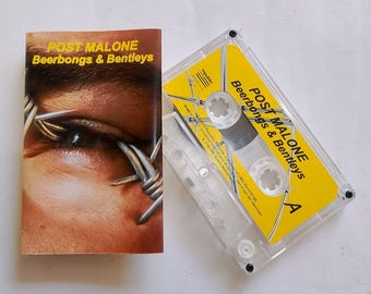 May include: A cassette tape and its case featuring the album "Beerbongs & Bentleys" by Post Malone. The case shows an eye with barbed wire. The cassette has a yellow label with the album title and artist name.
