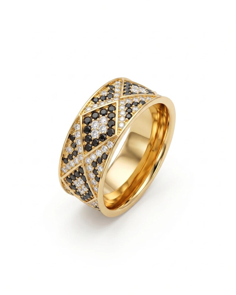 May include: A gold band ring featuring a geometric pattern of inlaid black and white stones. The outer surface is divided into triangular and diamond shapes, each filled with small, round, sparkling black and white stones set in gold.