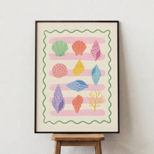 May include: A framed print featuring a collection of colorful seashells. The seashells are in various shapes and sizes, with shades of green, orange, pink, yellow, blue, and purple. The background has pink stripes and a green wavy border.