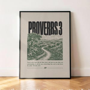 May include: A framed wall art print featuring the bold black text PROVERBS 3 at the top. Below is a detailed green ink illustration of a winding dirt path through a hilly landscape. The text Trust in the Lord with all thine heart is printed.