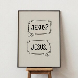 May include: A framed print with the words "JESUS?" and "JESUS." in black text within speech bubbles. The print has a neutral background and a dark brown frame, suitable for home or office decor.
