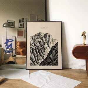 Climb On Mountain Print in frame on wall, vintage mountain art poster displayed in modern contemporary living room interior with eclectic decor, motivational nature landscape wall art