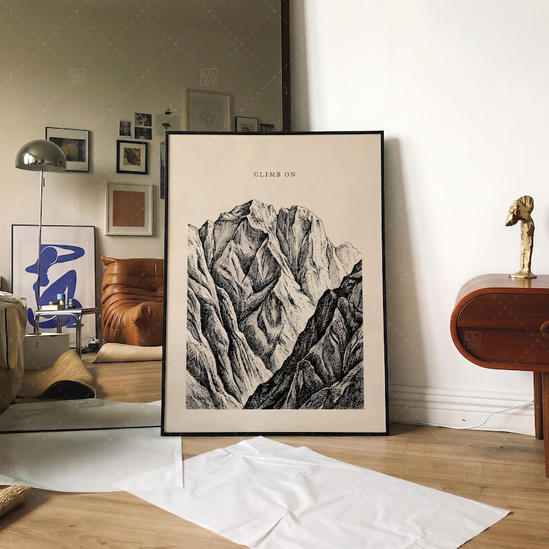 Climb On Mountain Print in frame on wall, vintage mountain art poster displayed in modern contemporary living room interior with eclectic decor, motivational nature landscape wall art