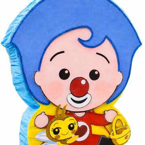 May include: A colorful pinata in the shape of a cartoon character with blue hair, a red nose, and a red outfit. A yellow bee with glitter accents is featured on the front. The pinata has a yellow and blue base.
