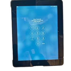 May include: A black iPad showing the passcode entry screen. The screen displays the text "Enter Passcode" and "iPad requires your passcode after restarting." A number pad with digits 0-9 is visible.