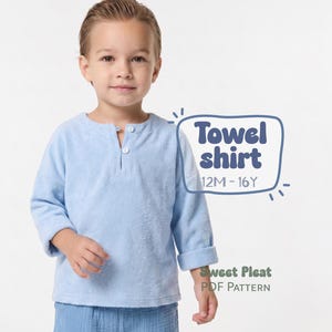 May include: A light blue long-sleeve shirt made of a textured towel-like fabric. The shirt features a round neckline with a small front placket and two white buttons. Text on the image reads: Towel shirt 12M - 16Y and Sweet Pleat PDF Pattern.