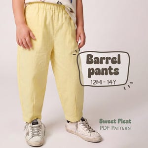 May include: Light yellow barrel pants with an elastic waistband and a tapered leg silhouette. The text on the image reads Barrel pants 12M-14Y and Sweet Pleat PDF Pattern. The pants are worn with white sneakers featuring grey laces and a star detail.