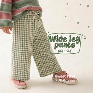 Könnte beinhalten: Ein Kind trägt eine Hose mit weitem Bein im Hahnentrittmuster und einen gestreiften Pullover. Die Hose hat ein hellgrünes und weißes Muster. Der Pullover hat rosa, grüne und weiße Streifen. Das Bild enthält den Text "Wide leg pants 6M-14Y".