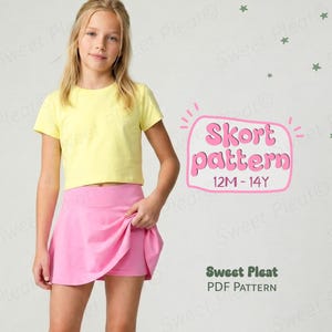 Op de afbeelding: Een jong persoon draagt een geel T-shirt en een roze skort. De afbeelding bevat de tekst "Skort pattern 12M-14Y" en "Sweet Pleat PDF Pattern". De achtergrond is lichtgrijs.