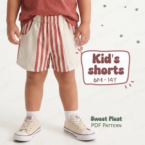 May include: A child wearing beige shorts with vertical red stripes and pockets. The shorts are paired with beige sneakers and white socks. The image includes the text "Kid's shorts 6M-14Y" and "Sweet Pleat PDF PATTERN".