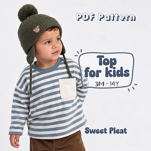 May include: An olive green knit hat with a pom-pom, ear flaps, and a small bear patch, paired with a blue and white striped long-sleeve shirt featuring a solid white chest pocket. Text reads: PDF Pattern, Top for kids, 3M-14Y, Sweet Pleat.