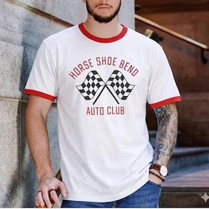 May include: White t-shirt with red trim. The shirt displays the text "HORSE SHOE BEND AUTO CLUB" and two crossed checkered flags. Made of a soft material.