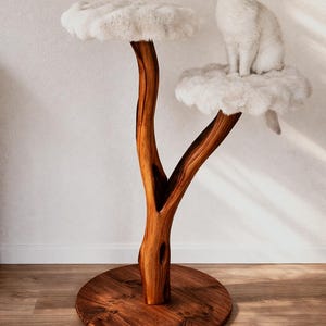 May include: A cat tree with a natural wood trunk and two cloud-shaped platforms covered in white faux fur. A white cat sits on the top platform. The base is a round, stained wooden disc.