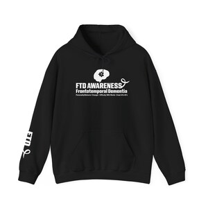 May include: Black hoodie with a front pocket and drawstring hood. The front features the text "FTD AWARENESS" above "Frontotemporal Dementia" and a brain graphic. The left sleeve has the letters "FTD" in white. The hoodie is a casual garment.