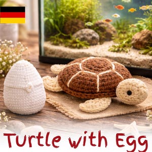 May include: A brown and cream-colored crochet turtle toy with a dark brown shell featuring white stitched lines, positioned next to a white crochet egg with a small button detail. The text "Turtle with Egg" and "CROCHET PATTERN" is visible.