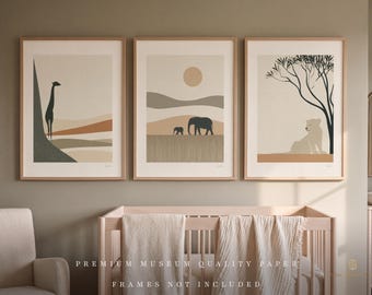 May include: Three framed wall art prints featuring minimalist safari animal illustrations. The left print shows a giraffe, the center print depicts elephants in a landscape with a sun, and the right print displays a lion resting under a tree.