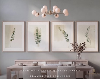 May include: A set of four framed wall art prints featuring watercolor botanical illustrations of green eucalyptus leaves on a neutral beige background. The text PREMIUM MUSEUM QUALITY PAPER FRAMES NOT INCLUDED is printed at the bottom.