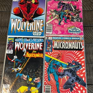 May include: Four vintage Marvel comic books. The covers feature colorful illustrations of superheroes, including Wolverine and characters from Micronauts. The comics are in protective sleeves and appear to be from the 1970s and 1980s.
