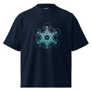 Puede incluir: Camiseta azul marino con un diseño geométrico en tonos turquesa y azul claro. El diseño es una compleja disposición de círculos y líneas interconectados. La camiseta tiene cuello redondo y mangas cortas. El nombre de la marca "EVETSU" está impreso en el cuello.