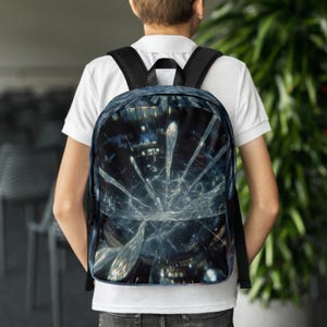 May include: A black backpack with a distinctive, abstract design. The design features a blue and white pattern resembling a shattered glass effect. The backpack has black straps and a black top handle.