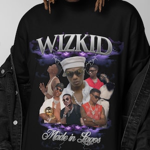 May include: Black long-sleeve shirt featuring a graphic of Wizkid with the text "WIZKID" in silver lettering above a collage of images. The text "Made in Lagos" is below the images.