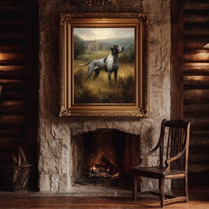 May include: A framed painting of a dog in a field, with a castle in the background, hangs above a stone fireplace. The painting has a gold ornate frame. A wooden chair sits to the right of the fireplace. The room has a rustic, cabin-like aesthetic.