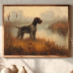 May include: A rectangular framed wall art print featuring an oil painting of a dark brown and black wirehaired pointing dog standing in tall golden-brown marsh grass beside a calm, misty lake during a soft, hazy sunrise or sunset.