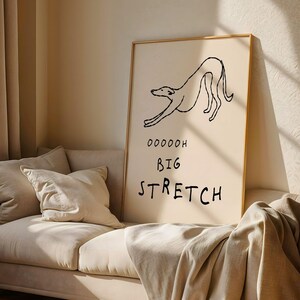 a large poster with a simple drawing of a dog and the text "OODDOH BIG STRETCH" written below it.