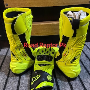 May include: Bright yellow motorcycle boots and gloves. The boots are tall, with black accents and the text "SUPERTECH". The gloves are black and yellow, with protective features. The text "Road Raptor Pk" is visible.