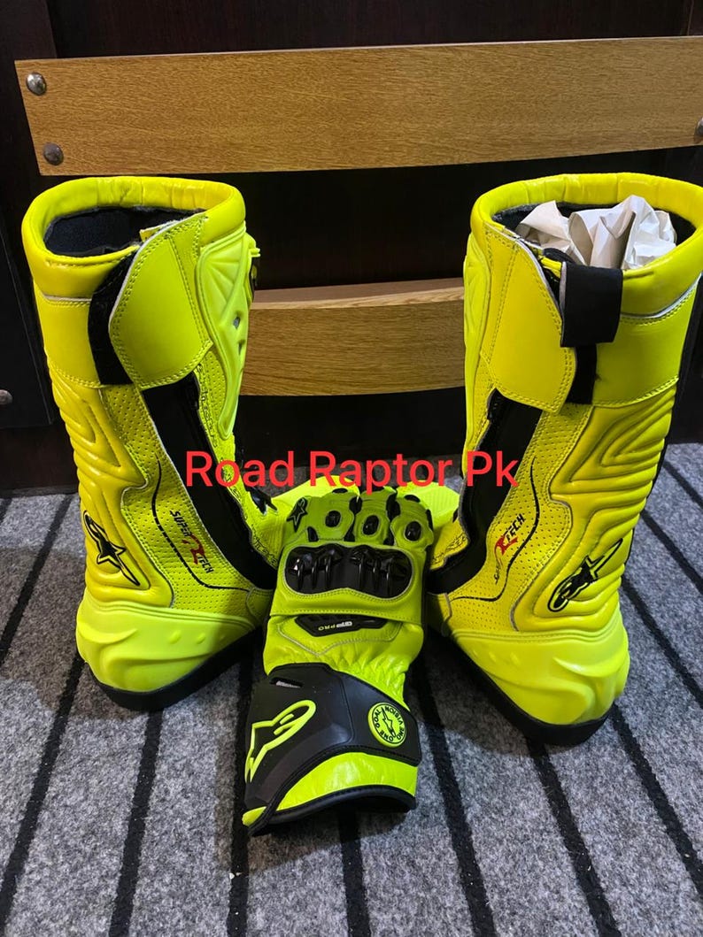 May include: Bright yellow motorcycle boots and gloves. The boots are tall, with black accents and the text "SUPERTECH". The gloves are black and yellow, with protective features. The text "Road Raptor Pk" is visible.