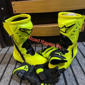 May include: A pair of neon yellow and black motorcycle boots and gloves. The boots are high-top with black accents and the gloves are black with neon yellow details. The text "Road Raptor Pk" is visible.