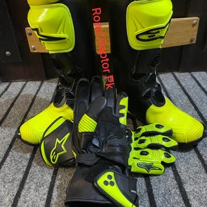 May include: Black and neon yellow motorcycle boots, gloves, and short gloves. The boots and gloves have the text "Road Raptor PK". The gloves and boots have the star logo.