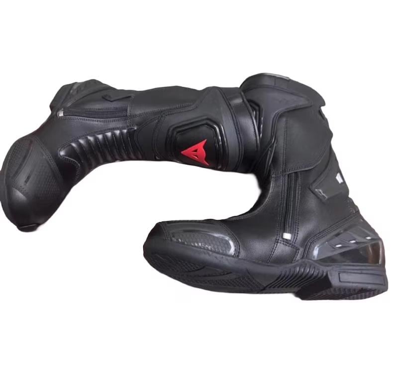 May include: Black motorcycle boot with a red logo. The boot features a zipper closure, reinforced panels, and a textured sole. The boot is designed for protection and performance.