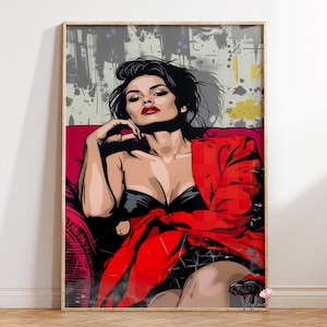 May include: A framed pop art print of a woman in a red jacket and black top, seated on a red couch. The artwork features bold lines and a vibrant color palette, with a background of abstract shapes and splatters.