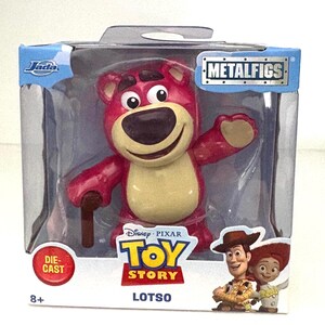May include: A die-cast Lotso figure from Disney Pixar's Toy Story, packaged in a clear plastic box. The figure is a pink bear with a tan belly, holding a brown cane. The packaging includes the Metalfigs logo and the Toy Story logo.