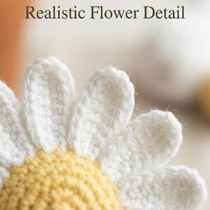 May include: Close-up of a crocheted daisy with white petals and a yellow center. The text "Realistic Flower Detail" is at the top of the image. The handmade flower is likely for home decor or crafting projects.