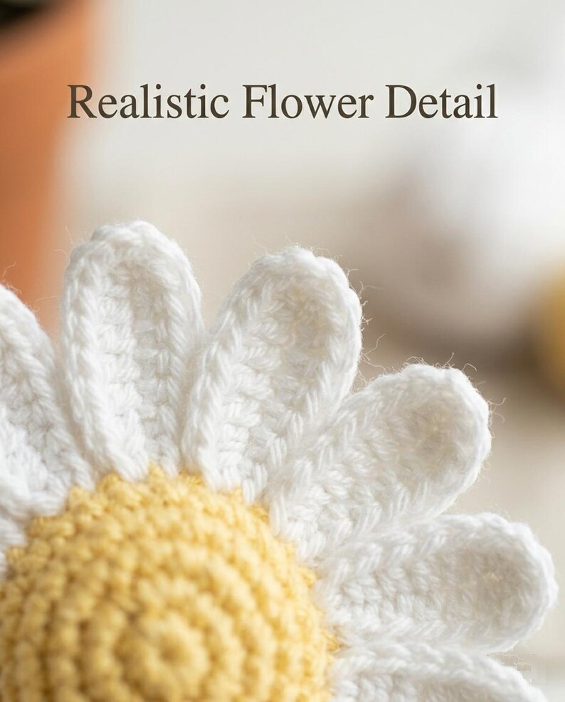 May include: Close-up of a crocheted daisy with white petals and a yellow center. The text "Realistic Flower Detail" is at the top of the image. The handmade flower is likely for home decor or crafting projects.