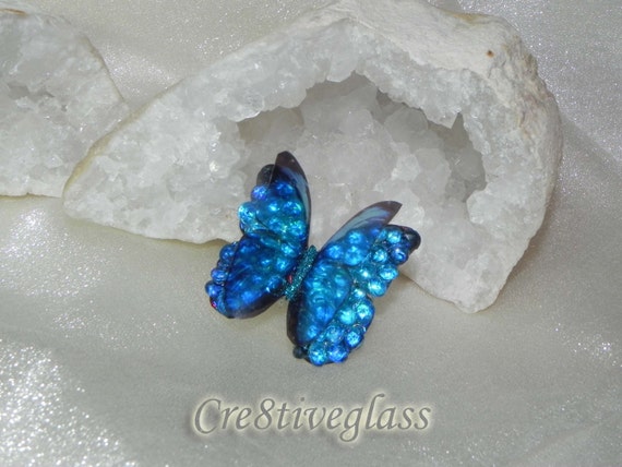 A handcrafted iridescent crystal butterfly embellishment with 105 hearts proving real demand — catches light like nothing mass-produced can.