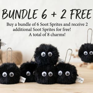 Handmade black soot sprite plush keychain attached to a pink canvas backpack, demonstrating the scale and fuzzy texture of the anime-inspired bag charm