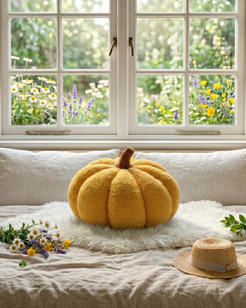 Three trendy boucle pumpkin cushions in sage green, white, and yellow sitting on a shelf. Infographic text highlights the 15cm, 25cm, and 35cm size options for handmade holiday living room decor.