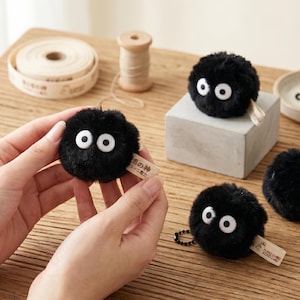 Professional product photo of a Soot Sprite plushie set featuring a buy 6 get 2 free discount offer for collectors.