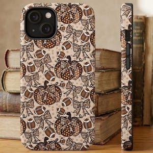May include: A smartphone case featuring a repeating pattern of brown and tan pumpkins, footballs, and bows on a light beige background. The design includes polka dot and leopard print details on the pumpkins and bows, with a side view showing buttons.